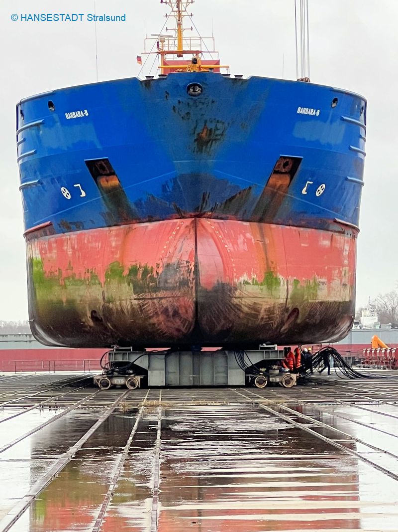 Das Schiff liegt auf dem Trockenen, darunter die Stapelwagen, auf denen das Schiff an seinen Reparaturplatz gerollt wird